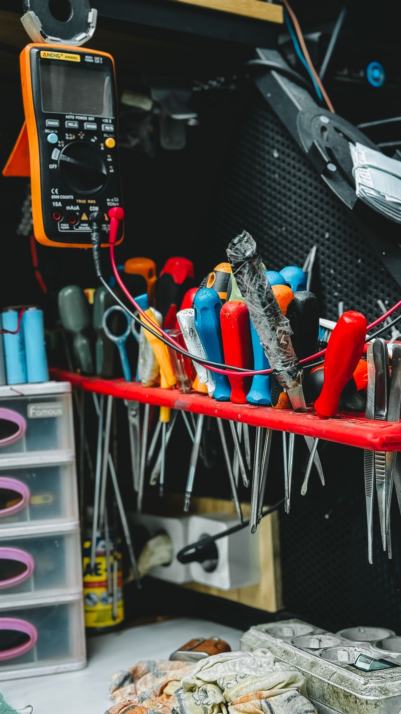 Tanning bed repair workbench with multimeter and tools used to diagnose and fix salon equipment