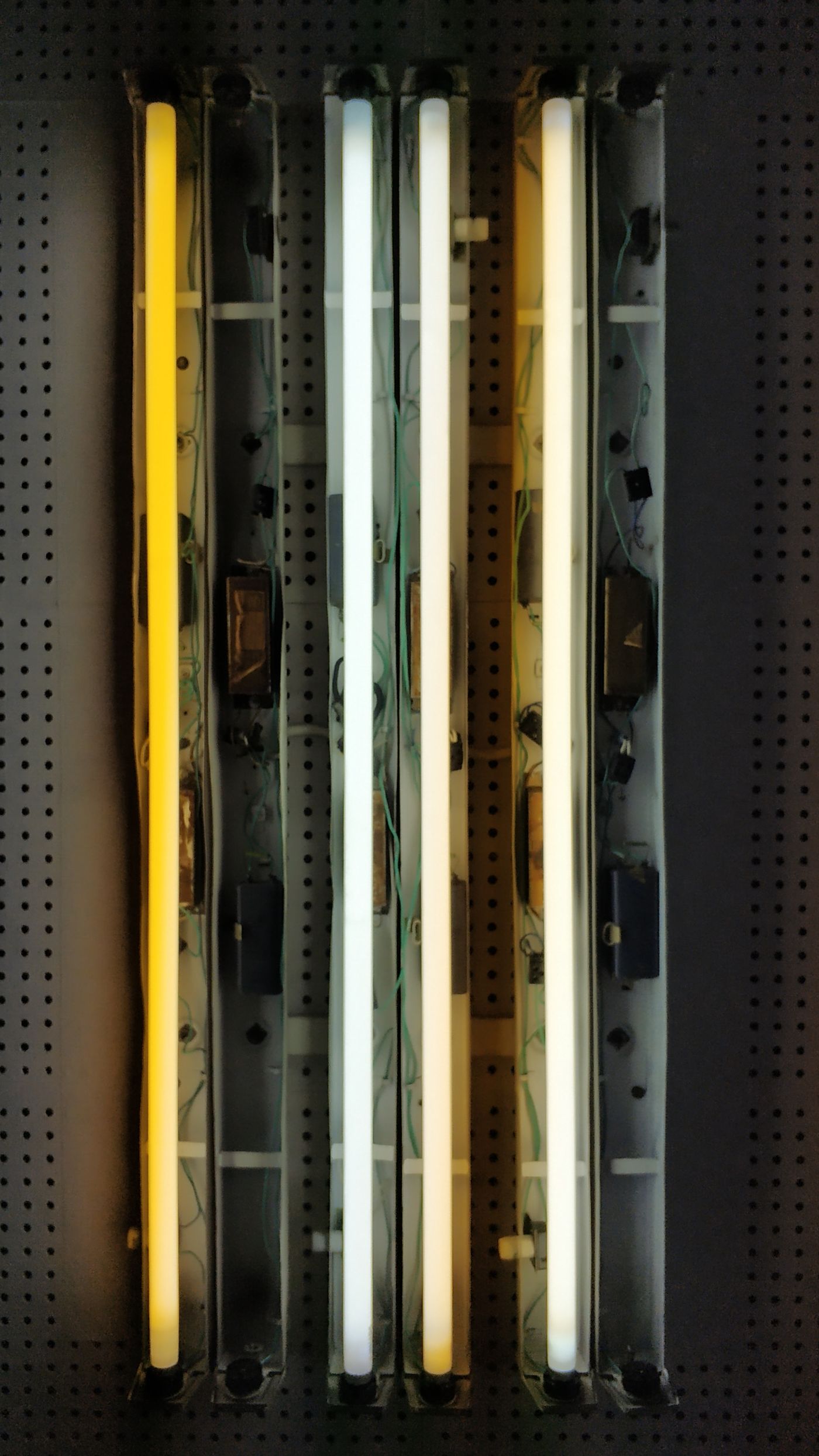 Glowing tanning bed UV lamps and ballast wiring serviced by Sun Systems and Service in Metro Detroit